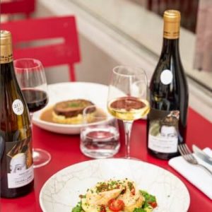 Une table à l'extérieur avec plats et vin au restaurant l'Ardoise du XV à Paris 15